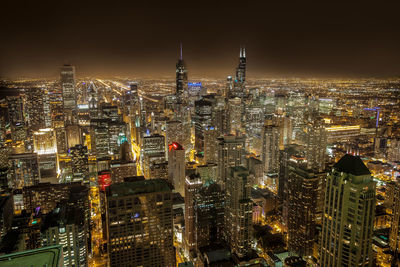 Aerial view of city lit up at night