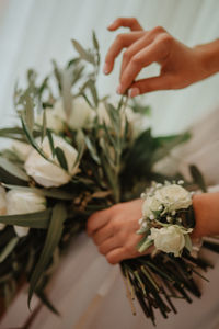 Close-up of woman holding bouquet of potted plant