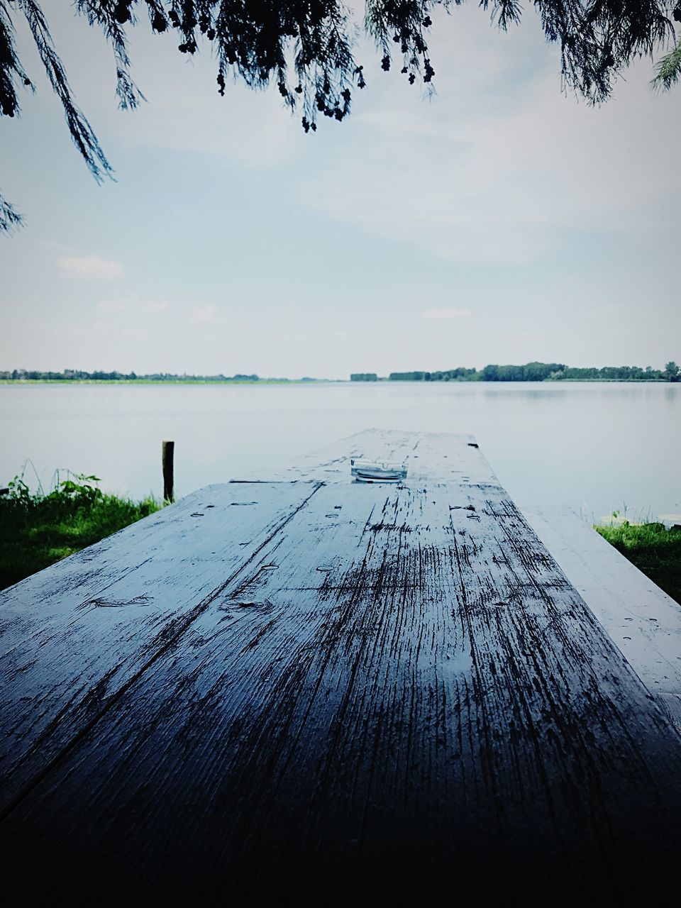 SURFACE LEVEL OF WOODEN POST AGAINST SKY