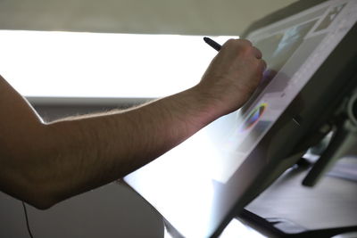 Close-up of man working on paper