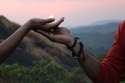 Cropped hand of woman holding sparkler