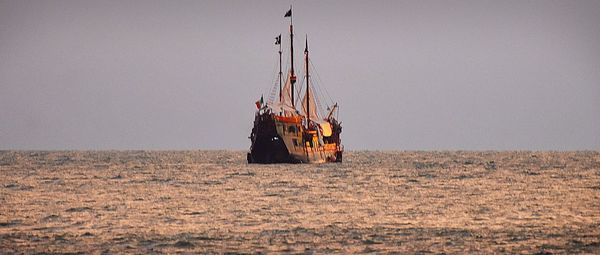 Sailboat on field against clear sky