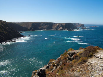 Scenic view of sea against clear blue sky