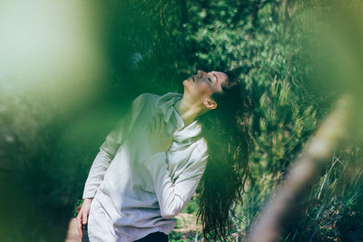 Woman dancing in forest