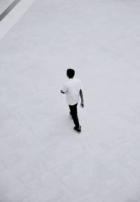 Rear view of man walking on floor