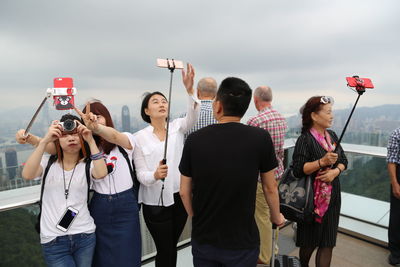 Rear view of people photographing