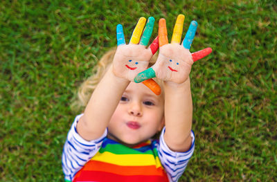 High angle view of cute girl playing with toys on grassy field