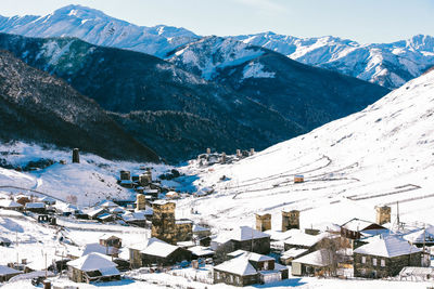 Scenic view of snowcapped mountains during winter wooden tower with a fence snow the village