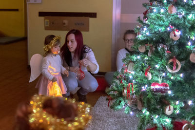 High angle view of girl and christmas tree