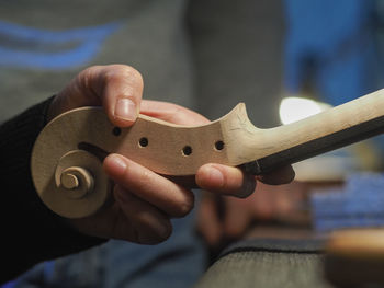 Luthier working a classic violin scroll