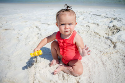 Full length of girl playing on beach