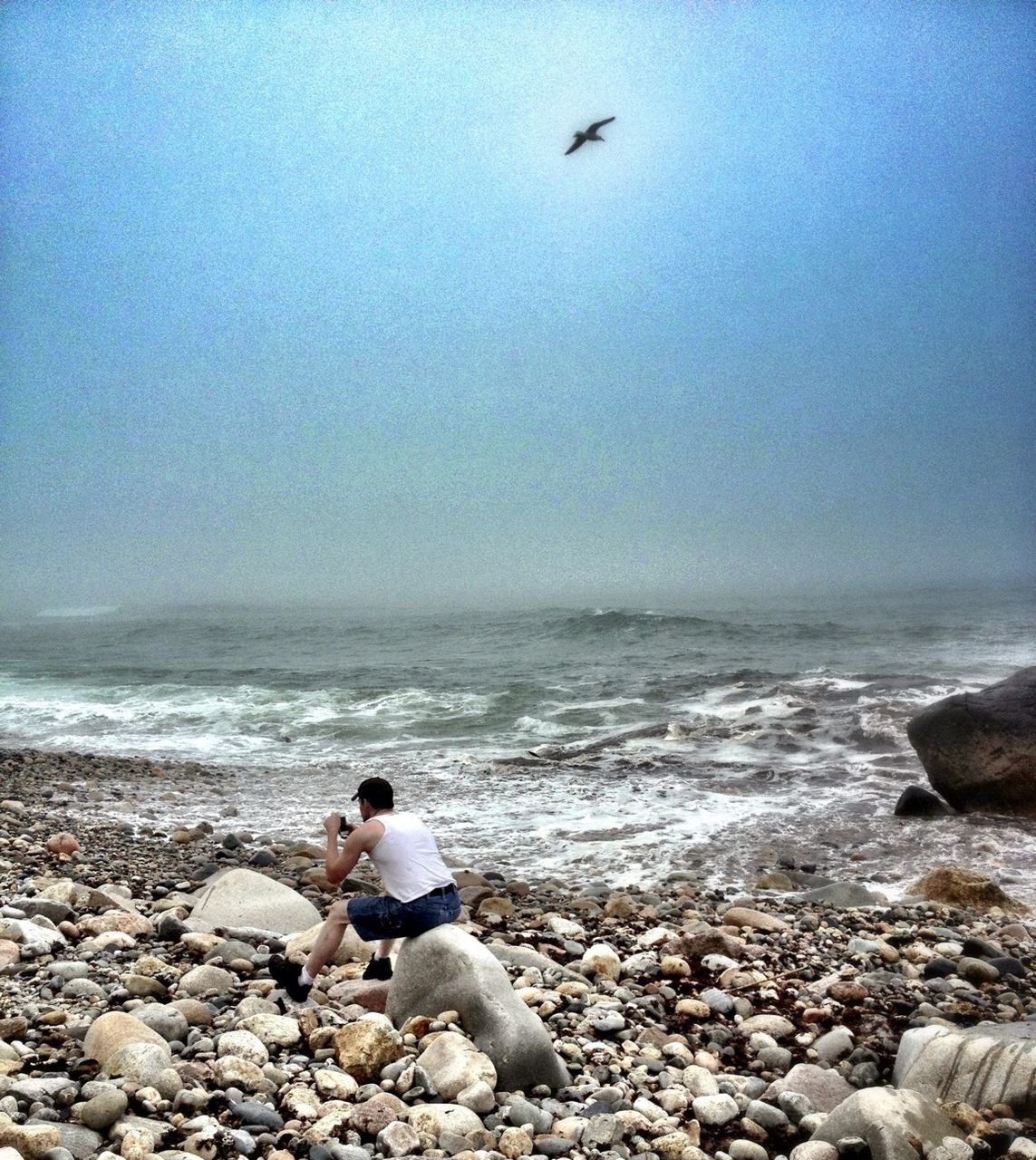 sea, horizon over water, water, beach, shore, rock - object, leisure activity, lifestyles, scenics, men, wave, beauty in nature, sky, vacations, nature, rock, tranquility, tranquil scene