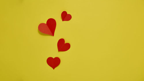 Close-up of heart shape against yellow background