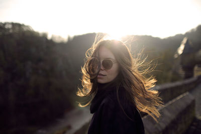 Portrait of beautiful woman against sky