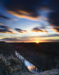 Scenic view of landscape against sky during sunset