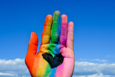 Close-up of hand holding blue sky