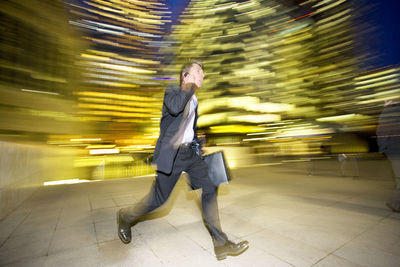 Blurred motion of man walking on the road at night