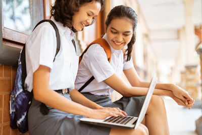 Young woman using laptop at home