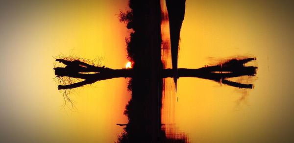 Silhouette of a boat in lake during sunset