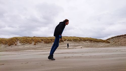 Side view of young man on land