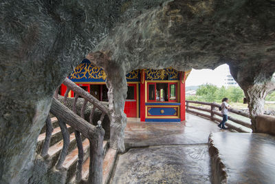 Red boat on rock in cave