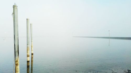 View of wooden posts in sea