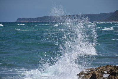 Sea waves splashing on rocks