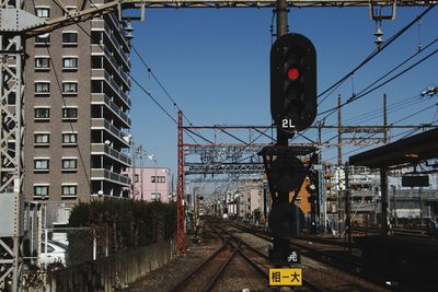 Train on railroad tracks in city against sky