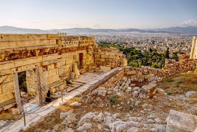 High angle view of woman standing in historical building against sky