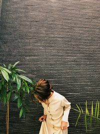 Woman standing against wall