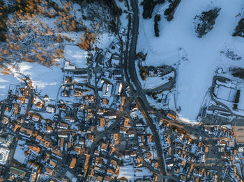 Aerial view of roads and townscape on snowy landscape during winter
