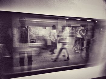 Young man looking through window