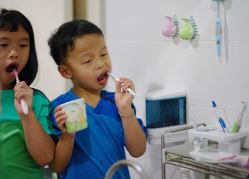 Siblings brushing in bathroom