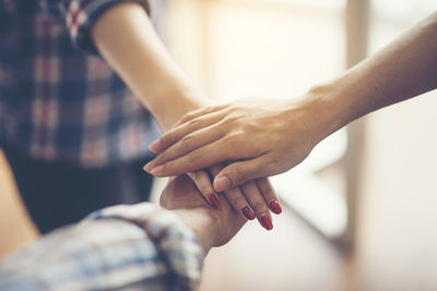 Midsection of couple holding hands