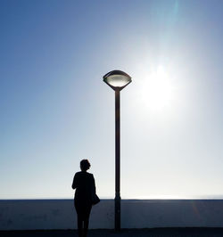 Silhouette of woman standing against clear sky