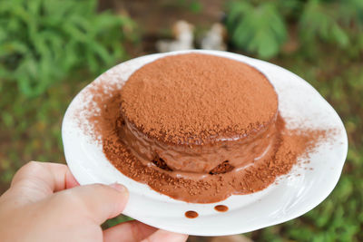 Close-up of hand holding ice cream