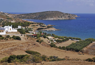 Scenic view of sea and mountains against clear sky