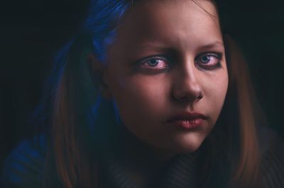 Portrait of sad teenage girl at home during halloween