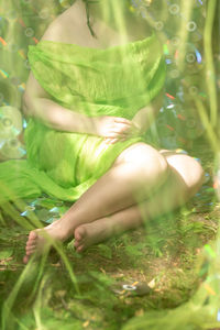 Low section of woman lying on field