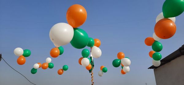 Low angle view of balloons against sky