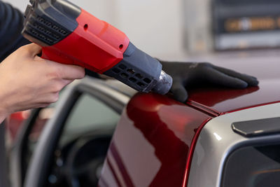 Cropped hand of man holding steering wheel