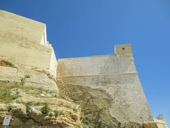 Low angle view of built structure against clear blue sky