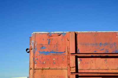 Low angle view of buildings against clear blue sky