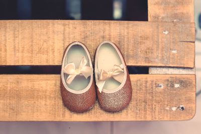 Directly above shot of small sandals on wooden table