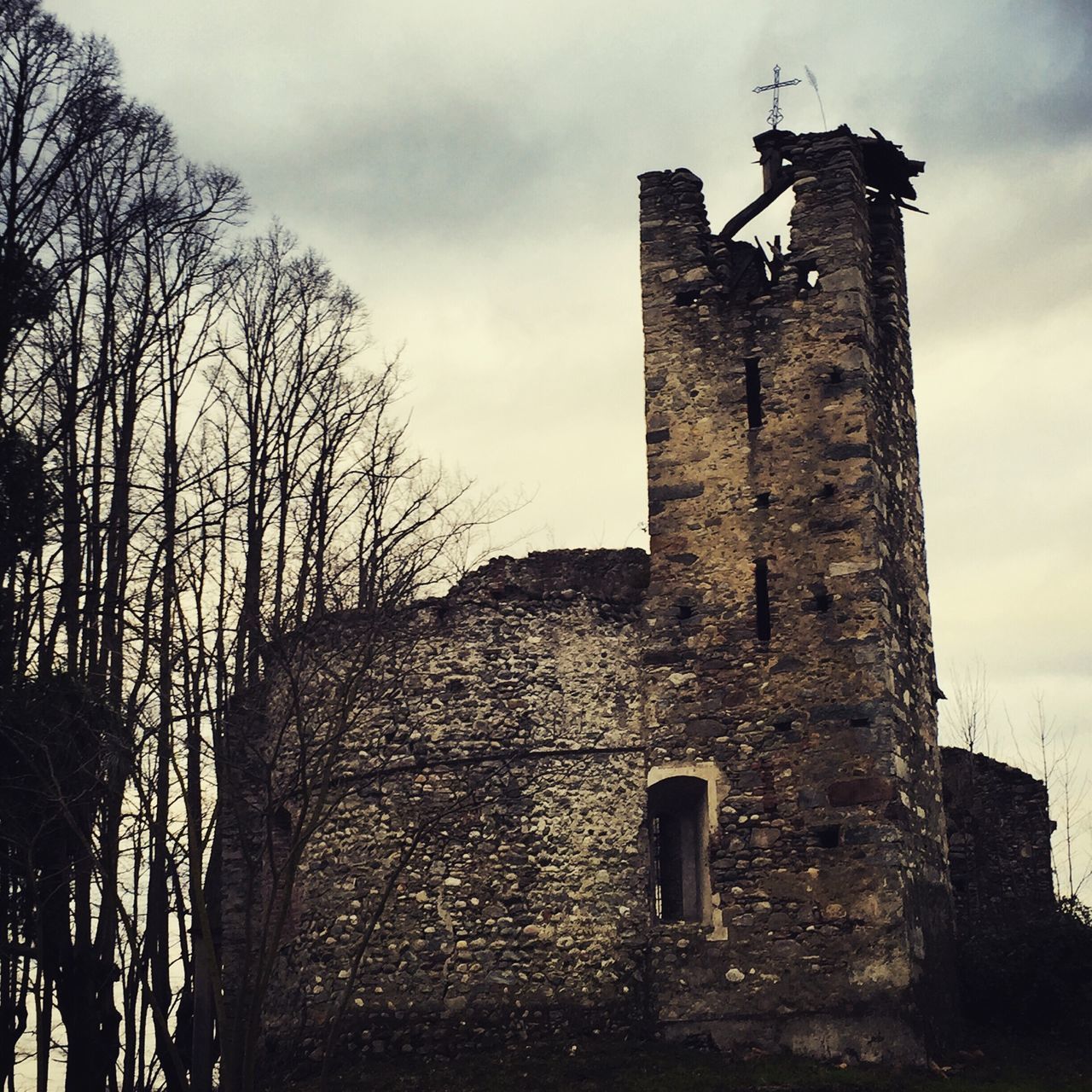 architecture, built structure, building exterior, sky, religion, low angle view, old, church, spirituality, cross, abandoned, cloud - sky, place of worship, damaged, history, deterioration, weathered, run-down