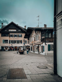 Street amidst buildings against sky