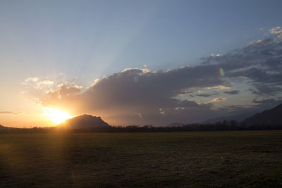 Scenic view of field against sky during sunset