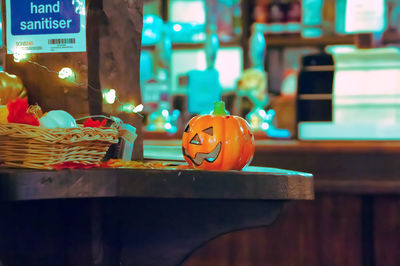 Close-up of jack o lantern on table, halloween decorations,spooky restaurants for halloween, pumpkin 