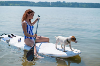 Portrait of woman with dog in sea