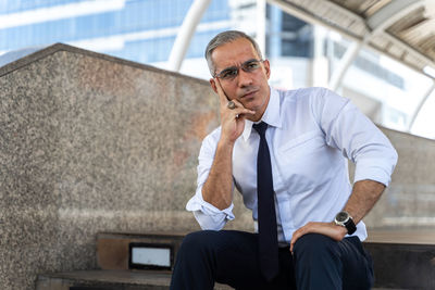 Portrait of a young man sitting outdoors